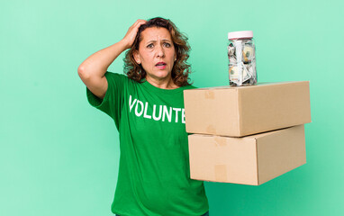 middle age woman feeling stressed, anxious or scared, with hands on head. volunteer and donation...