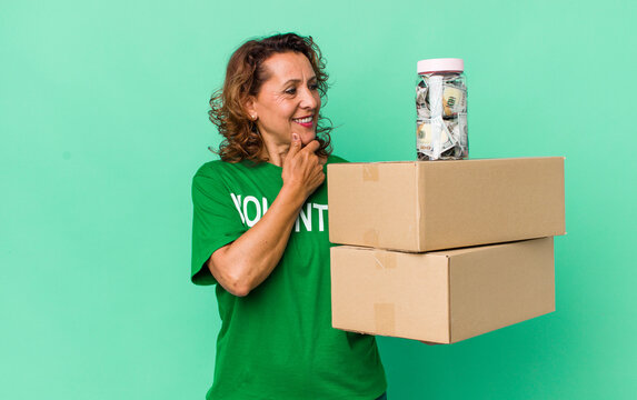 Middle Age Woman Smiling With A Happy, Confident Expression With Hand On Chin. Volunteer And Donation Concept