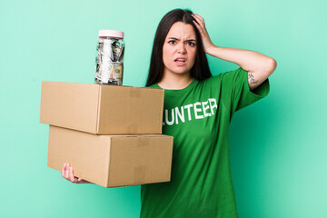 young adult woman feeling stressed, anxious or scared, with hands on head. donation concept