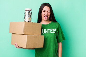 young adult woman with cheerful and rebellious attitude, joking and sticking tongue out. donation...