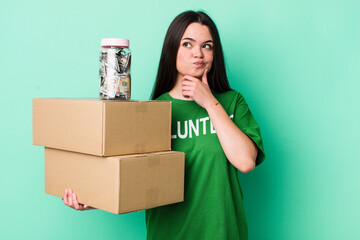 young adult woman thinking, feeling doubtful and confused. donation concept