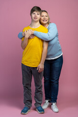 Mom hugging son standing looking at camera