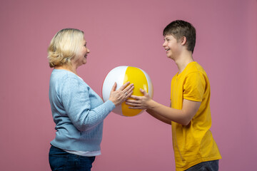 Guy and woman touching ball sideways to camera