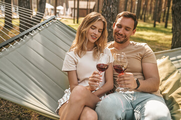 Attractive young romantic couple drinking red wine