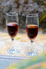 two glasses with red wine in the tropics garden