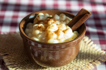 traditional sweet from the Brazilian June festivals, made of white corn with coconut and condensed milk and sprinkled with cinnamon