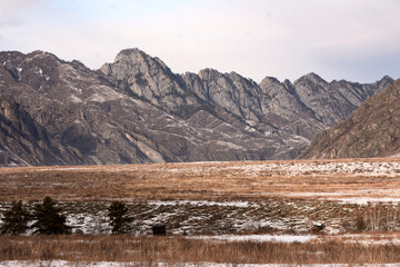 View of the winter big valley surrounded by high snow-capped mountains.