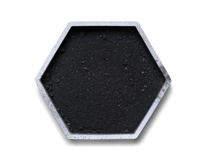 Carbon Charcoal Powder in hexagonal molecular shaped container on white background.