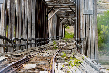 old abandon train car railway bridge falling apart after years of neglect 
