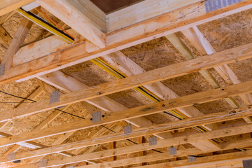Standard timber framed building with close up on the roof trusses workers nailing wood beams