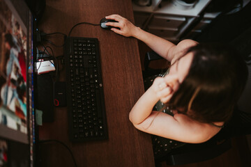 Woman working on her computer in her home office