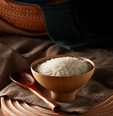 Raw rice in wooden bowl
