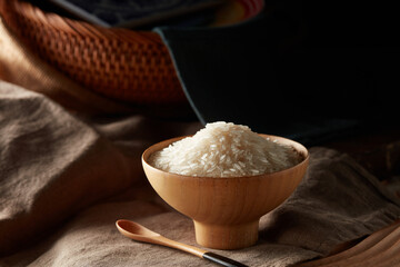 Raw rice in wooden bowl