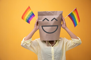 Woman in paper bag over her head with rainbow flags needs time to happiness for equality....