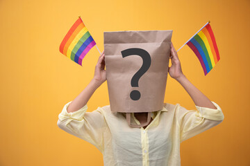 Various concepts about gender diversity or LGBT issues. Woman in paper bag over her head with...