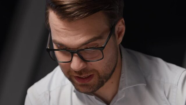 Portrait of a young man in eyeglasses explaining business strategy