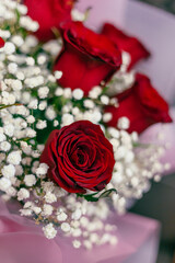 Red roses and white flowers with pink paper