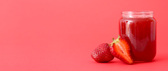 Jar of tasty strawberry jam on red background with space for text