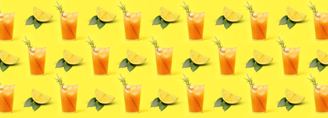 Many glasses of tasty cold iced tea with lemons on yellow background
