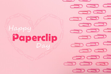 Many paperclips on pink background. Greeting card for National Paperclip Day