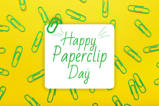 Many paperclips on yellow background. Greeting card for National Paperclip Day