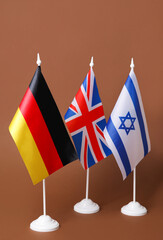 Flags of Germany, Great Britain and Israel on color background