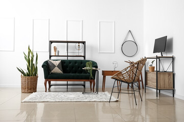 Modern living room interior with stylish sofa, houseplant and armchair