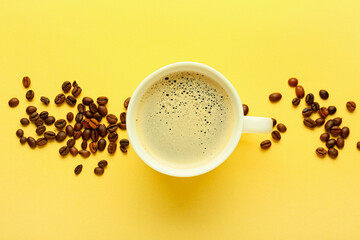 Cup of hot aromatic coffee and beans on color background