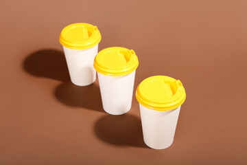 Takeaway paper cups on brown background