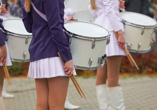 Girls in white skirts with drums