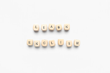 Wooden cubes with text LEARN ENGLISH on white background