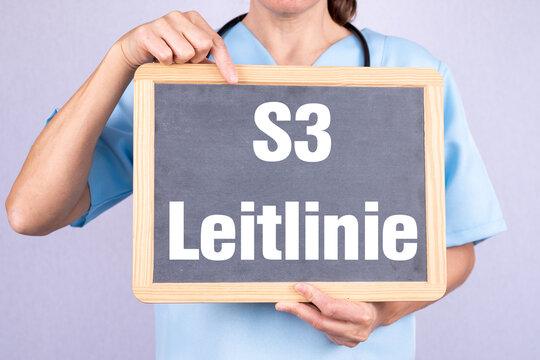 &Auml;rztin mit einer Tafel auf der S3 Leitlinie steht