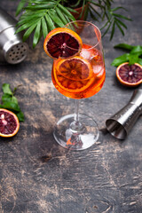Obraz na płótnie Canvas Aperol spritz cocktail in big wine glass with bloody oranges