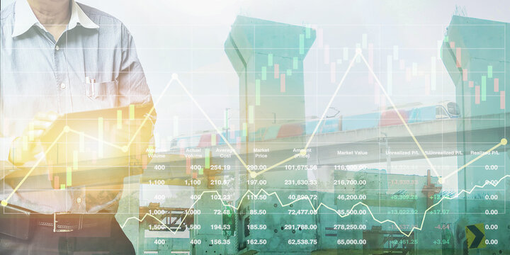 Stock financial index with graph, chart and candlesticks data on image of engineer standing using tablet control and manage work for skytrain transportation business  construction industry background.