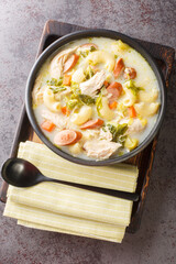 Chicken Sopas or Chicken Macaroni Soup Filipino Style close-up on a plate on the table. Vertical top view from above