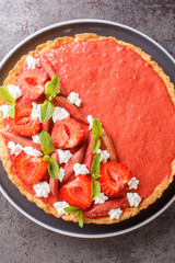 rhubarb strawberry tart with mousse close-up on the table. Vertical top view from above