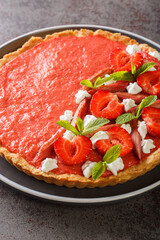 rhubarb strawberry tart with mousse close-up on the table. Vertical