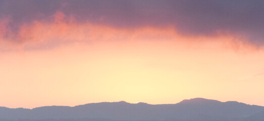 Fototapeta na wymiar Sky, clouds and mountain silhouette at sunset, panorama