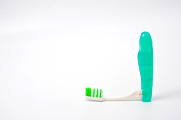 Folding plastic toothbrush for travel and tourism, shot on a white background.