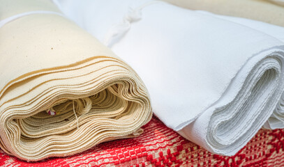 Romanian traditional material fabric rolls on table