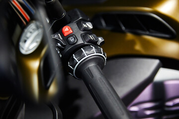 Motorcycle handle bar with buttons on blurred background