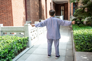 Hospital patient is exercising outdoors