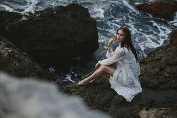 Woman in white dress rocky company nature ocean waves unaltered