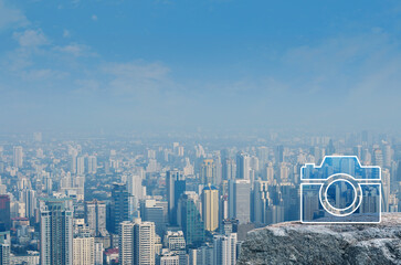 Fototapeta na wymiar Camera flat icon on rock mountain over modern city tower, office building and skyscraper, Business camera service concept