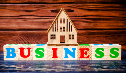 Wooden home and text on the cubes  business

