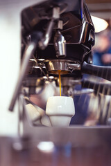 Espresso shot getting brewed into beautiful cup. Artistic photo.