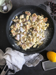 Top view of Kaiserschmarrn in cooking pan, typical Austrian dessert