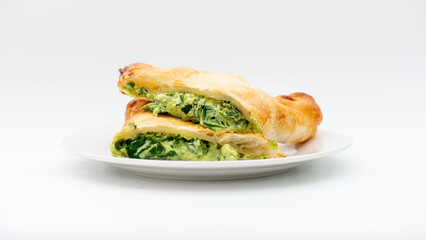 Fresh baked golden flaky spinach and feta pastie