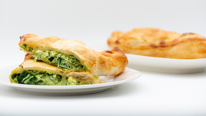 Fresh baked golden flaky spinach and feta pastie