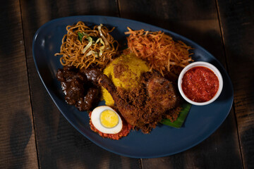 Nasi Kuning or Indonesian Yellow Rice in Fragrant Coconut Milk And Turmeric has favourable symbolic meanings. The yellow-coloured rice is perceived to look like a pile of gold.